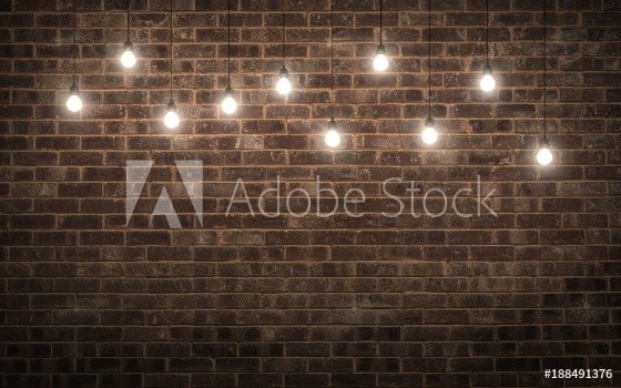 Picture of Shining light bulbs on dark brick wall 3d rendering